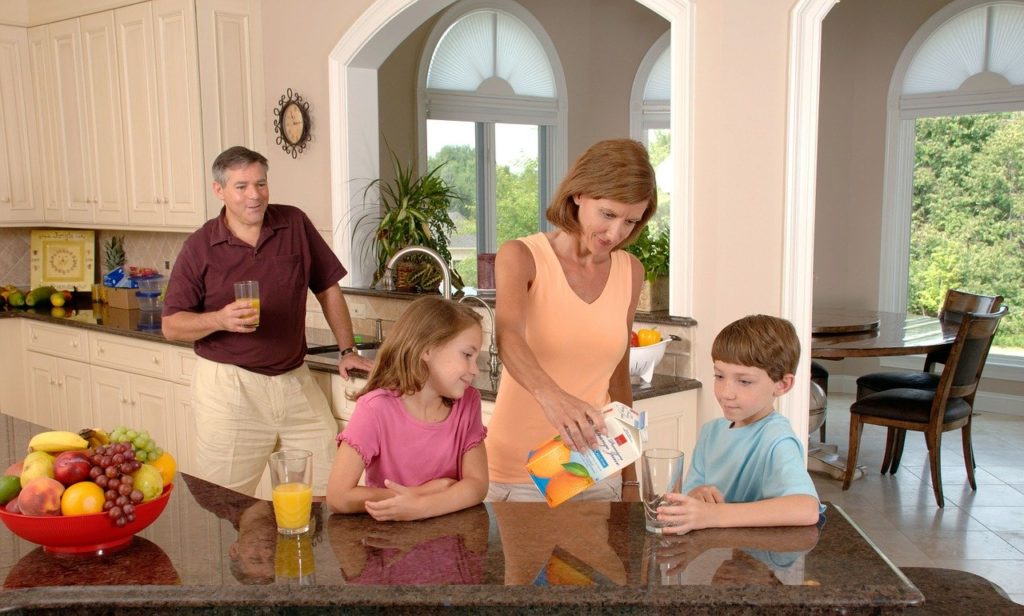 family drinking orange juice, glass, pouring